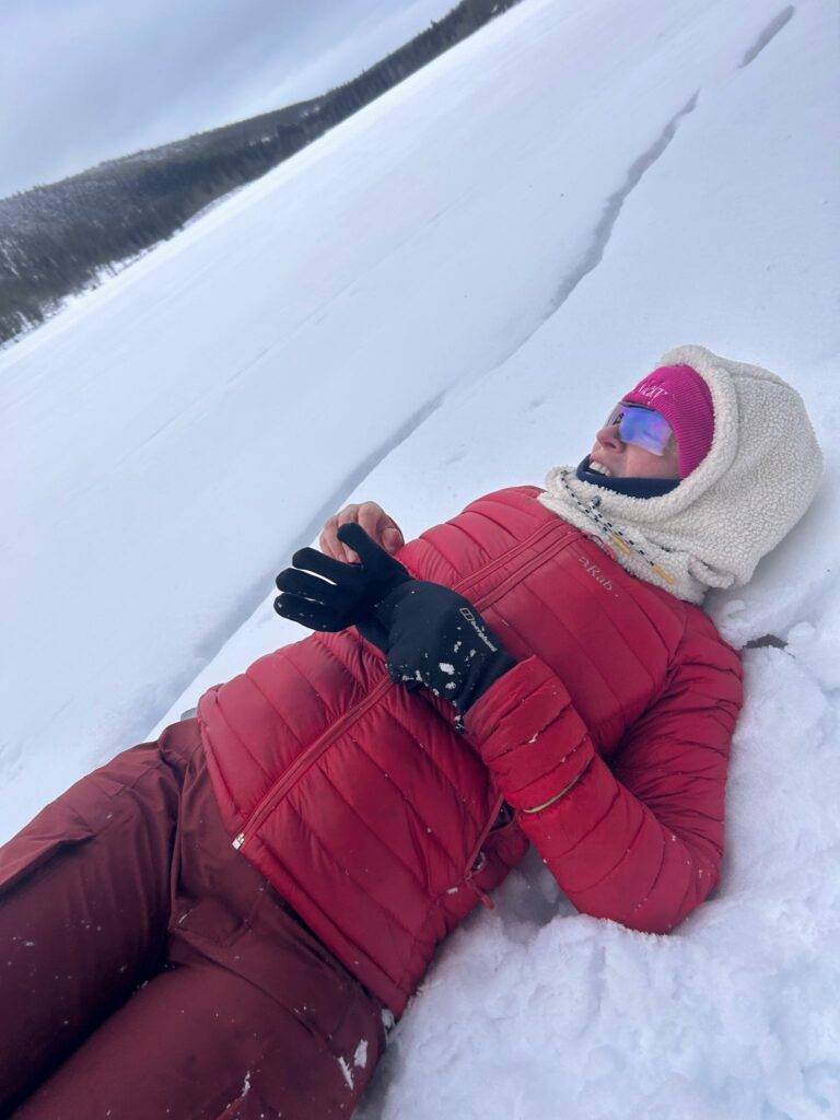woman laying in the snow