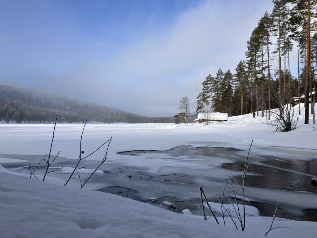 Frozen Lake in Sweden with cabins on the shoreline