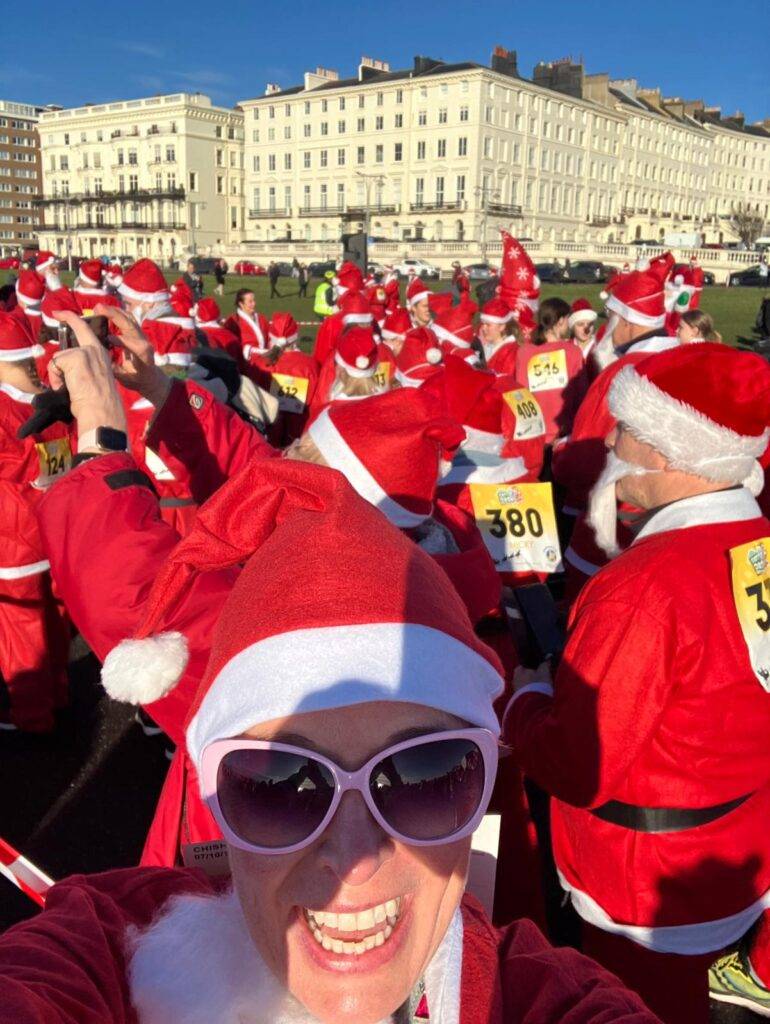 The photo on the right is me with 500 Santas raising money for a local charity in Brighton; it's become an annual event that we all look forward to!