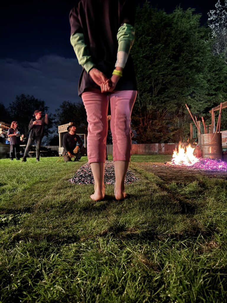 woman just about to step on the hot coals to start her firewalk