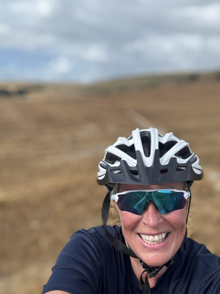 10 Activities to complete this Autumn - - woman in bike helmet on the hills